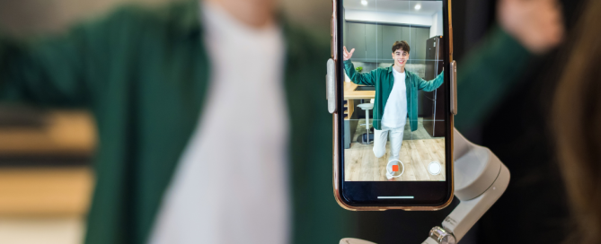 Person recording a video with a smartphone on a gimbal, showcasing influencer content creation